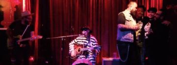 CROSBY TYLER-THE ONE MAN TUB-THUMPIN' BAND: playing his own bass, drum, guitar and singing at the same time, performs story-telling songs of prisons, drunks, trains, outlaws and black sheeps of life