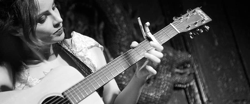 Rebecca Jed playing guitar